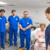 Adaptor CO2 Victoria S2200 GAUMARD | Simulasi EtCO2 2 Nursing students in blue scrubs practicing patient care using a medical mannequin.