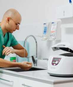 A medical professional practicing hand hygiene in a clinical setting.