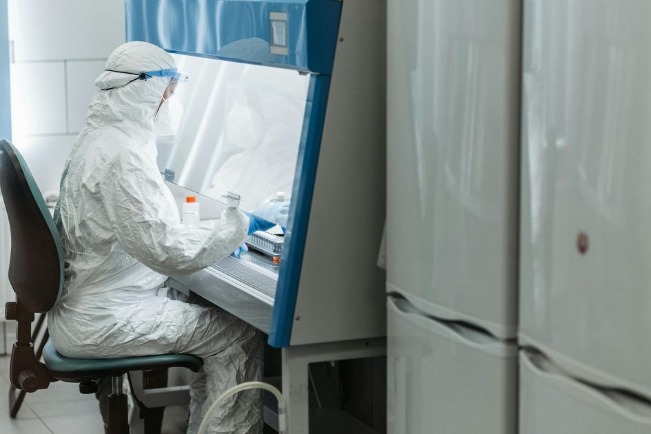 Bio Safety Cabinet - Pavel Danilyuk Scientist in protective gear working with laboratory equipment in a controlled environment.