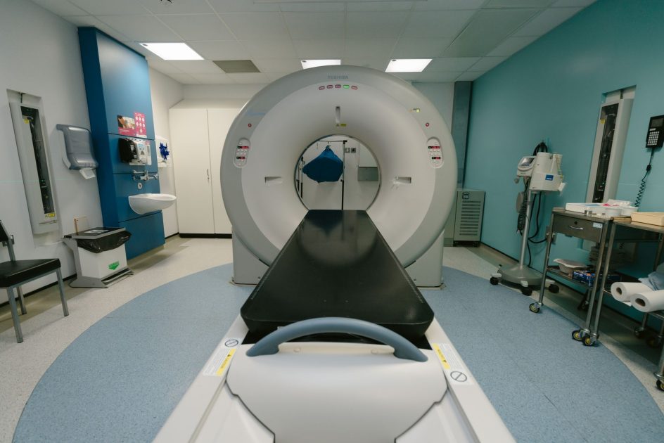 GE IVY CTM-400 Cardiac Module - Jo McNamara A high-tech MRI machine in a spacious hospital examination room, ready for medical scanning.