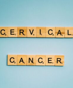 Scrabble tiles spelling 'Cervical Cancer' on a light blue background for awareness.