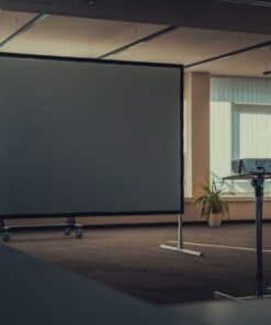 Spacious modern office interior featuring a projector and screen for presentations.