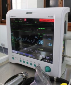Close-up of an advanced medical monitor displaying ECG data in a clinic.