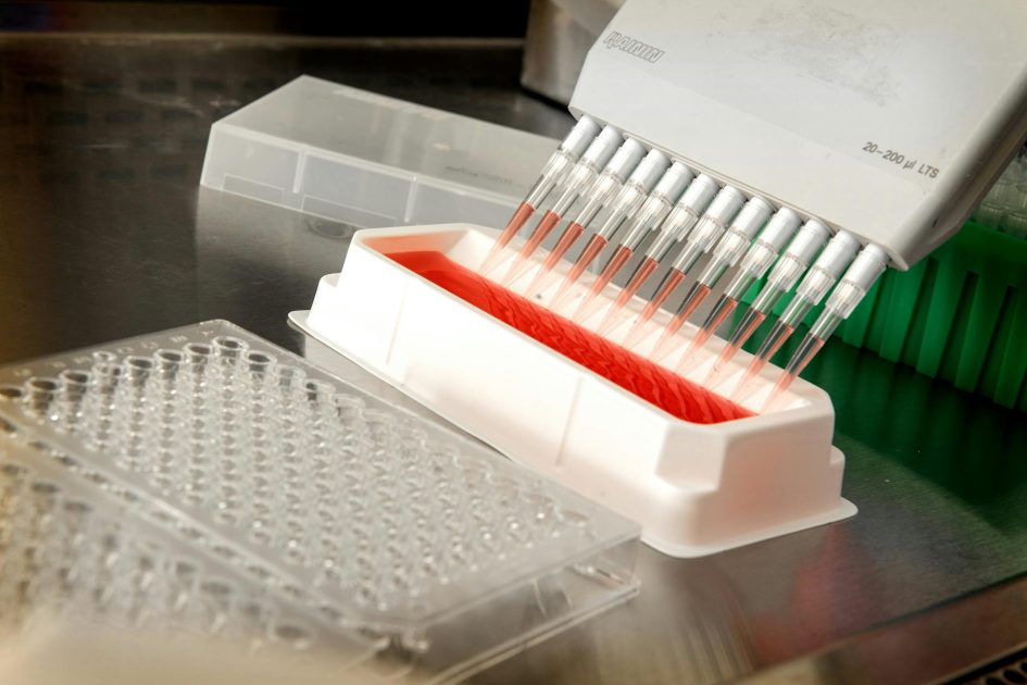 boric acid for molecular biology - CDC Close-up of an automated pipetting system dispensing liquids in a scientific laboratory.