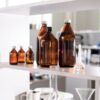 Brown glass bottles on a laboratory shelf, ideal for science-related contexts.