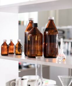 Brown glass bottles on a laboratory shelf, ideal for science-related contexts.