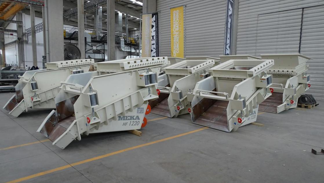 Row of heavy-duty industrial machinery inside modern factory facility.