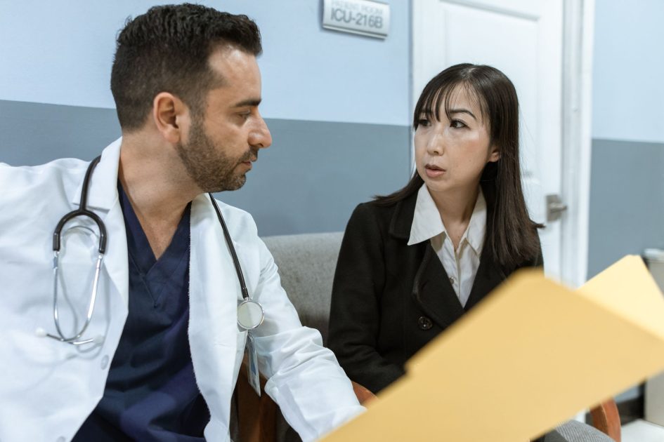 Bupati Bulukumba Paparkan Usulan Infrastruktur: 7 Fakta Penting 1 A doctor consults with a colleague in a hospital, examining medical documents.