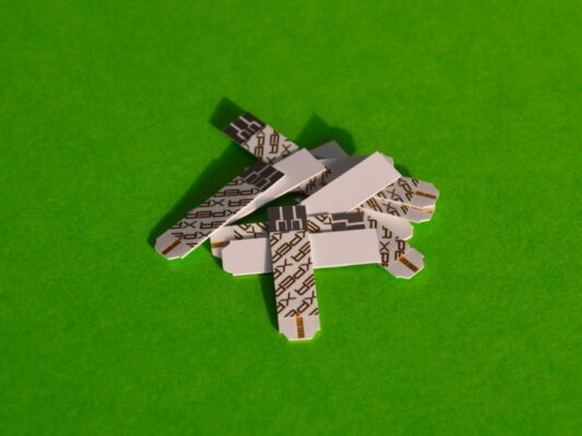 A pile of diabetes test strips on a bright green surface, symbolizing health management.