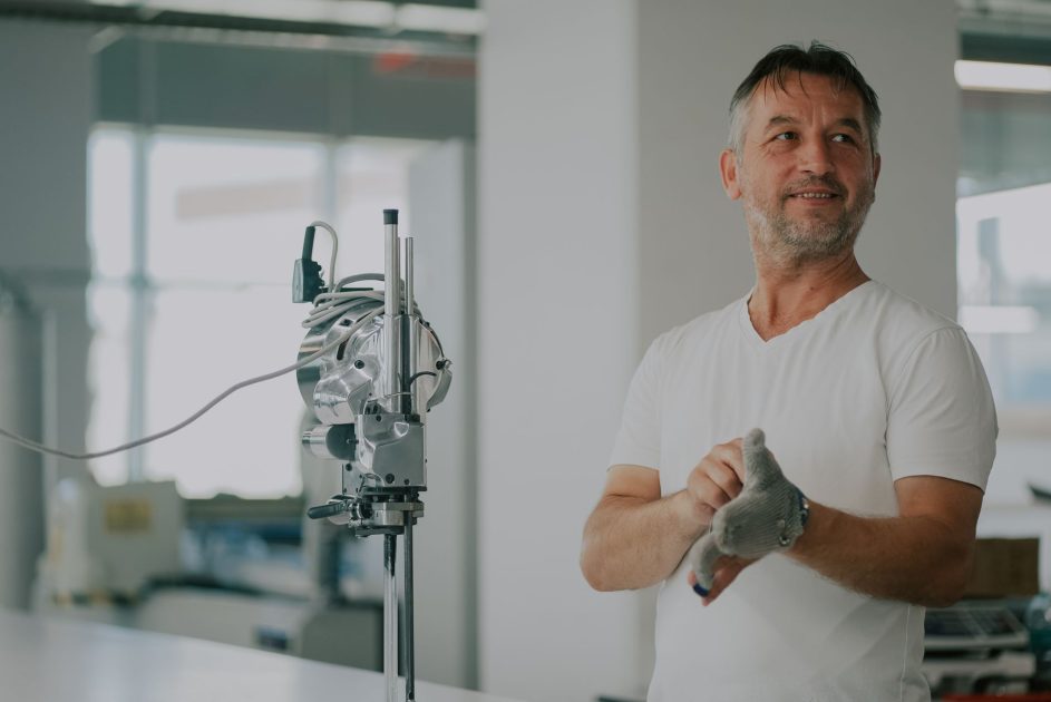 EMMI Bidik Peluang Pesatnya Pertumbuhan: 5 Strategi Bisnis Alat Kesehatan 2024 1 Adult man in an industrial workshop with textile machinery, preparing for work.