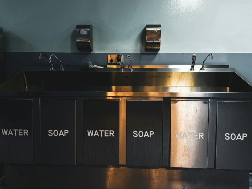 Foot Eye Washer Stainless Steel: Panduan Lengkap 2024 1 A stainless steel industrial kitchen sink with labeled compartments for water and soap.