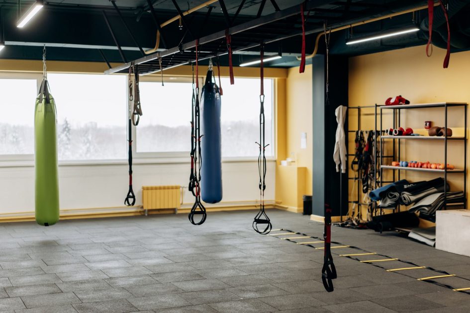 Gym Gratis Masjid: 7 Cara Unik Jaga Kebugaran Jemaah 1 A modern gym with equipment, punching bags, and open space for workouts.
