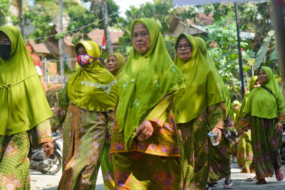 A group of women in matching green outfits.