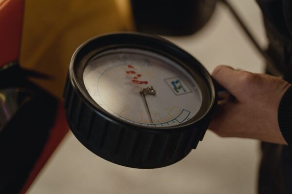 Detailed close-up of a hand holding a pressure gauge, ideal for mechanical themes.