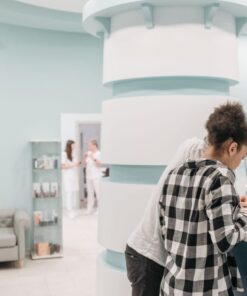 Healthcare professionals assisting at a modern clinic reception desk.