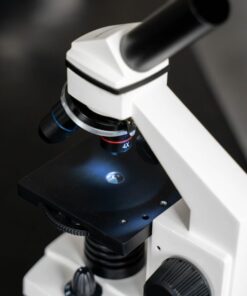 Close-up view of a laboratory microscope with selective focus, ideal for scientific use.