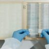 Close-up of scientist handling microscope slides in laboratory setting.
