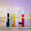 Vibrant test tubes filled with liquids in a modern lab setting, showcasing scientific exploration.