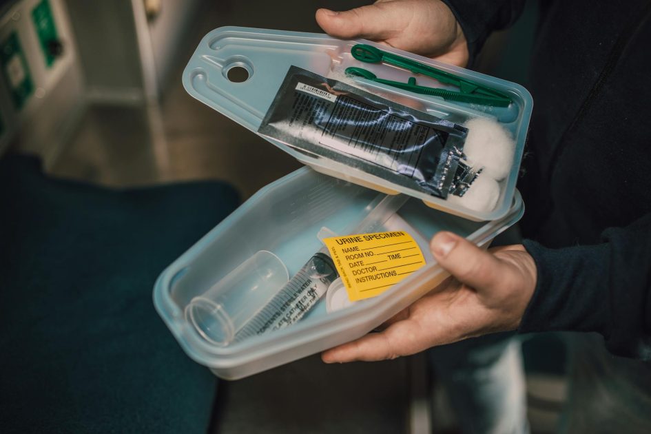 plastic container 350 ml specimen - RDNE Stock project Close-up of medical kit containing syringe and urine specimen label.