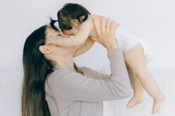 A tender moment between a mother and her baby, embracing love and care.