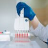 Jual GOSSELIN Serological Pipettes 10 ml GPN-10-E1 1 Close-up of a lab technician using a multichannel pipette for testing in a laboratory.