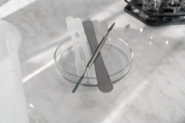 A detailed close-up of various laboratory tools placed on a glass plate, ideal for scientific research themes.