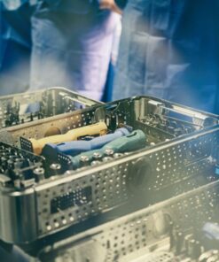 Close-up of sterilization trays containing surgical instruments in a medical setting.
