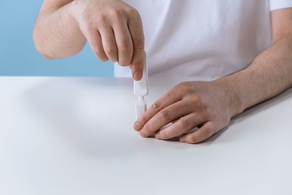 BPOM RI Temukan Obat Batuk Palsu: 7 Bahaya & Cara Aman 2025 1 Hands preparing a medical self-test kit on a white table. Health and diagnostic concept.