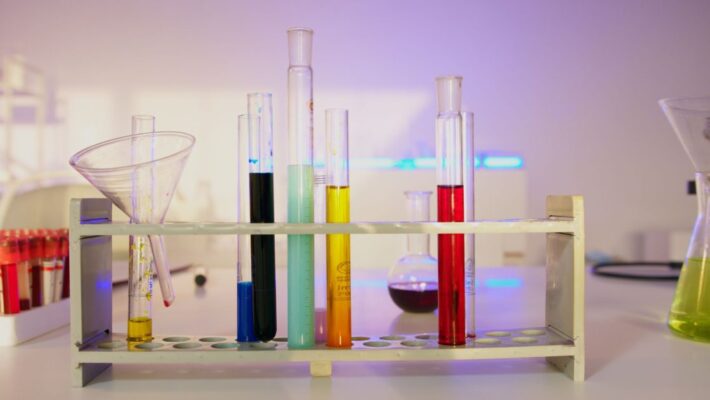 Vibrant test tubes filled with liquids in a modern lab setting, showcasing scientific exploration.