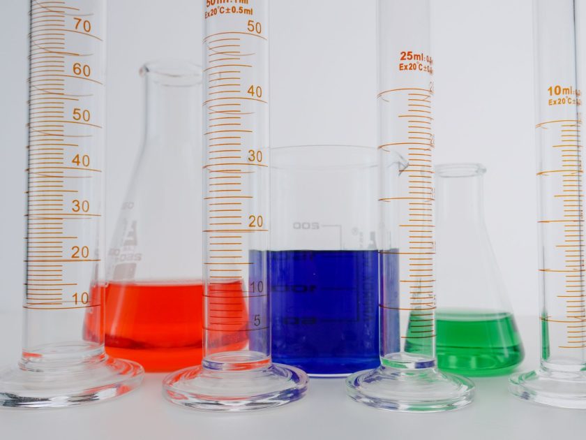 Close-up of colorful liquids in various laboratory glassware, perfect for science themes.