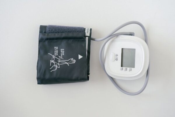A digital sphygmomanometer on a white background, used for measuring blood pressure.