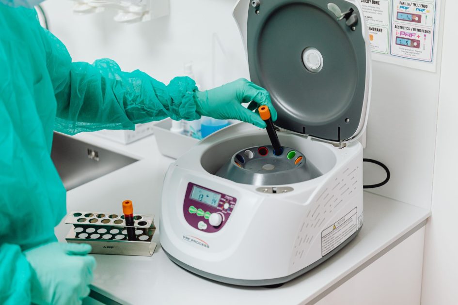 Import Alat Lab ke Indonesia: 12 Pertanyaan Sering Dijawab 1 A healthcare professional operates a centrifuge machine in a laboratory, ensuring sterile medical procedures.