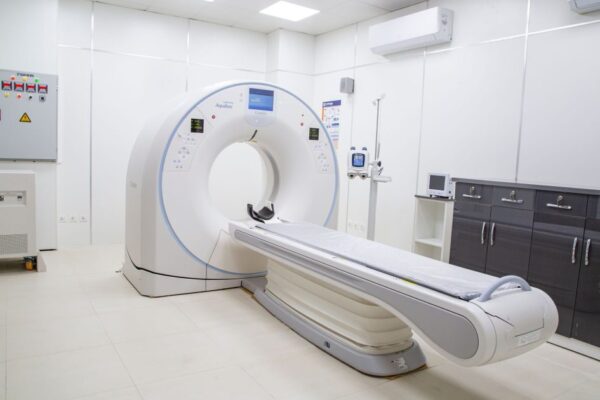 High-resolution image of a modern, clean MRI scanner room in a hospital facility.