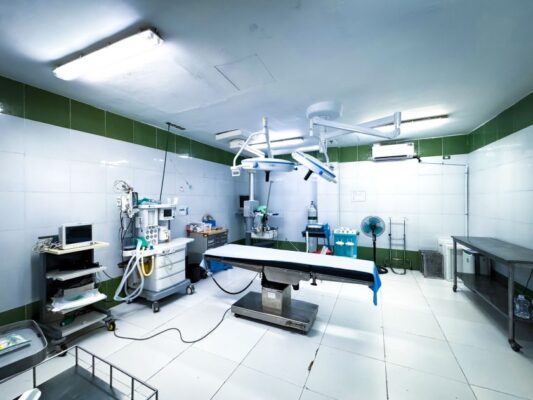 Brightly lit operating room equipped with advanced medical technology and clean facilities.