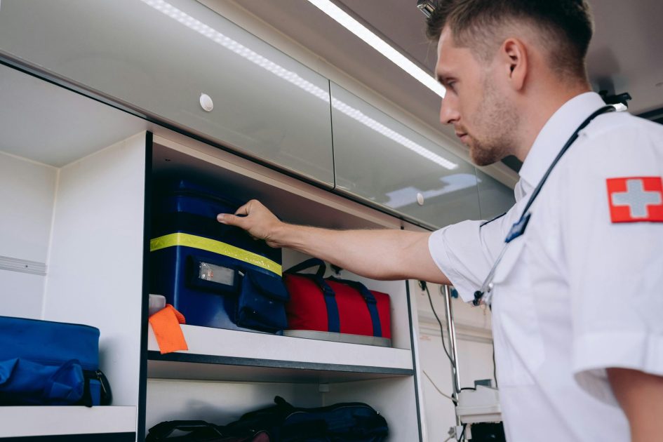 Update Gempa NTT M 7,7: Panduan Kesehatan & Alat Medis Darurat 1 A paramedic organizes medical supplies inside an ambulance shelf for emergency preparedness.