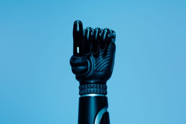 Close-up of a prosthetic arm in a vibrant blue setting, showcasing advanced technology.