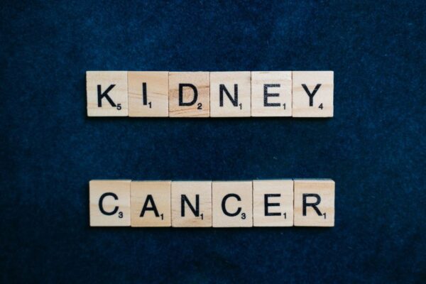 Close-up of the words 'Kidney Cancer' in Scrabble tiles on a dark blue background.