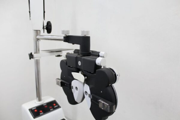 A phoropter used in optometry for eye examination in a bright medical office.