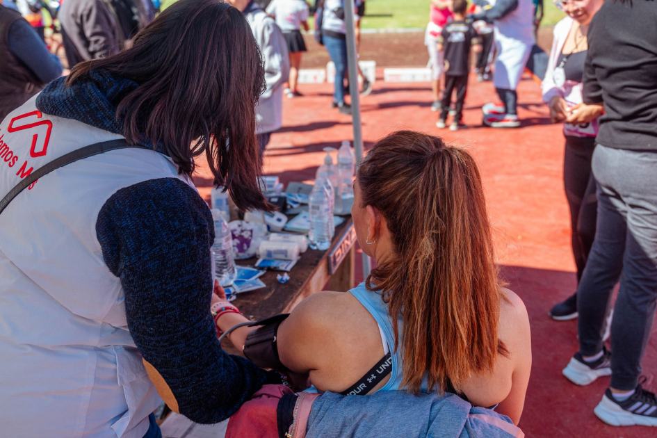 First aid being administered at an outdoor sports event with attendees.